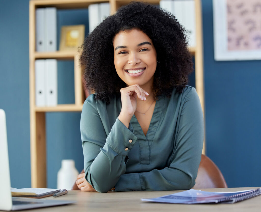 Business, woman and portrait of lawyer or legal advocate at her desk in the office ready for a case. Attorney, front and african American businesswoman proud of her management law firm workplace
